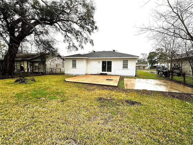 back of house with a patio and a yard