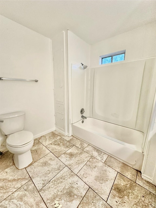 bathroom featuring toilet and  shower combination