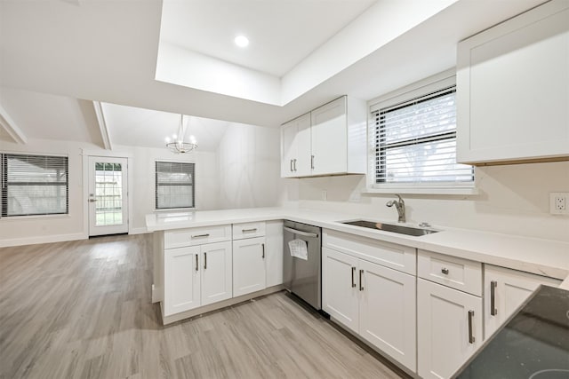 kitchen featuring light countertops, white cabinets, dishwasher, and decorative light fixtures