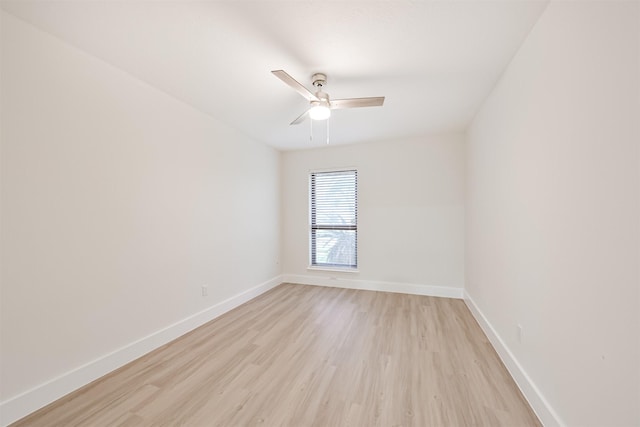 unfurnished room featuring baseboards, a ceiling fan, and light wood-style floors