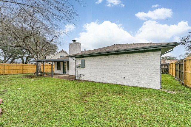 rear view of property featuring a patio area, a fenced backyard, and brick siding