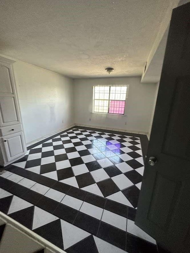 unfurnished room featuring a textured ceiling