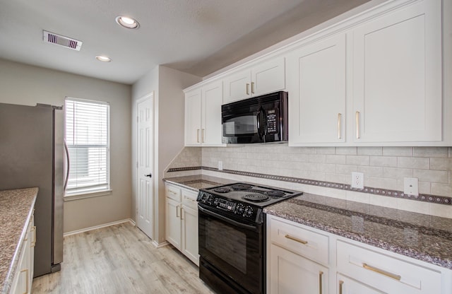 kitchen featuring light hardwood / wood-style flooring, tasteful backsplash, white cabinets, black appliances, and dark stone countertops