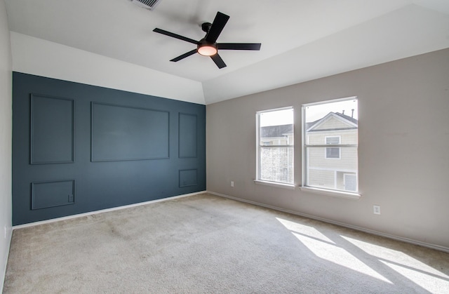 carpeted spare room with lofted ceiling and ceiling fan