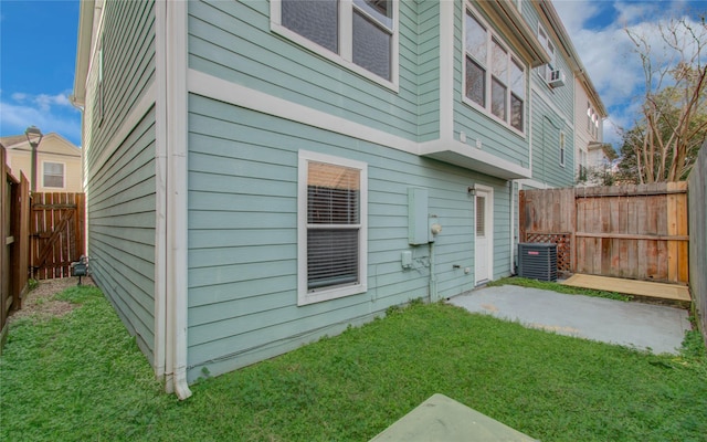 back of house featuring a yard, cooling unit, and a patio area