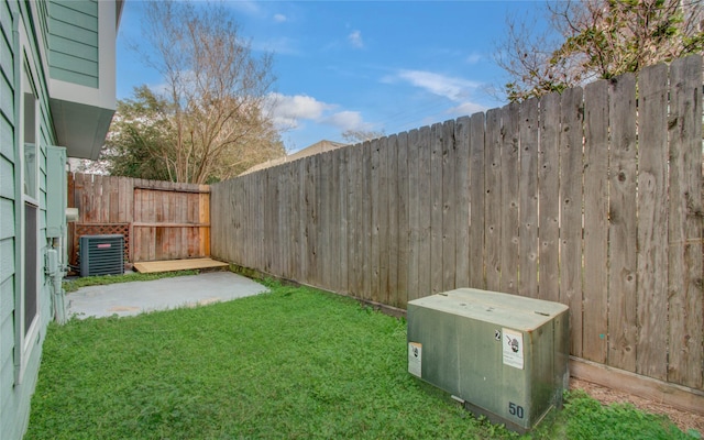 view of yard featuring a patio and central AC