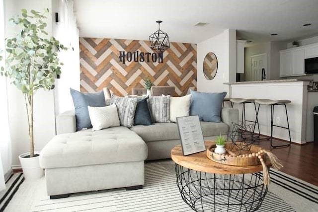 living room with hardwood / wood-style flooring and sink