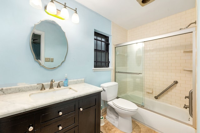 full bathroom with toilet, tile patterned flooring, vanity, and enclosed tub / shower combo