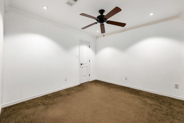 carpeted spare room with ceiling fan and ornamental molding