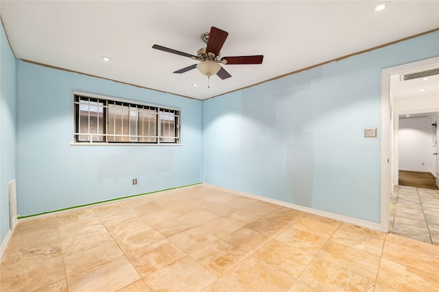 empty room featuring ceiling fan and ornamental molding