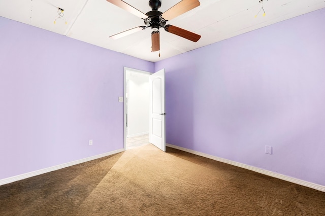 empty room featuring ceiling fan and carpet flooring