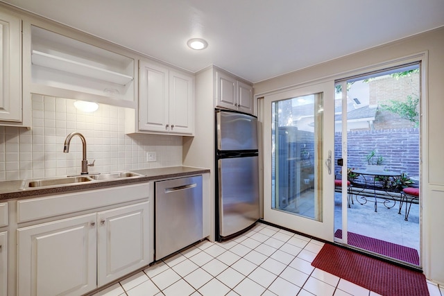 kitchen featuring a sink, white cabinets, appliances with stainless steel finishes, open shelves, and dark countertops