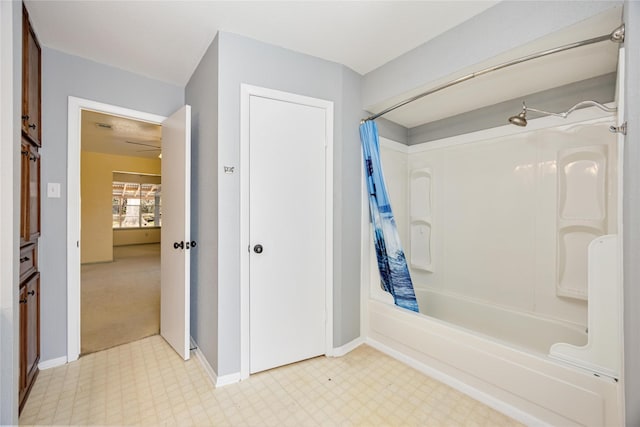 full bath with baseboards, shower / tub combo, and tile patterned floors