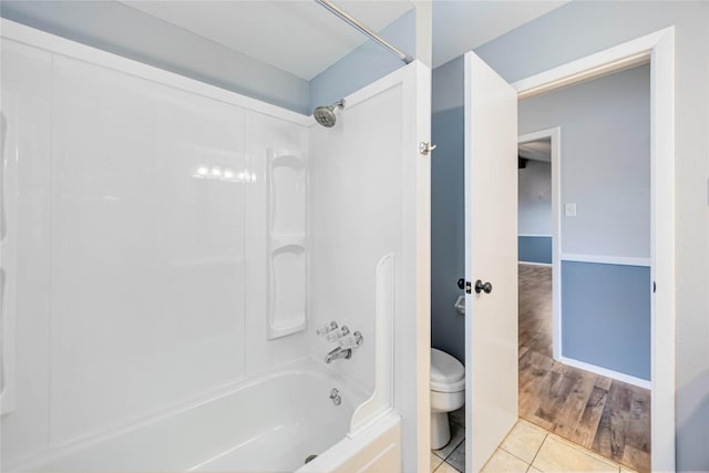 full bathroom featuring toilet, shower / tub combination, baseboards, and tile patterned flooring