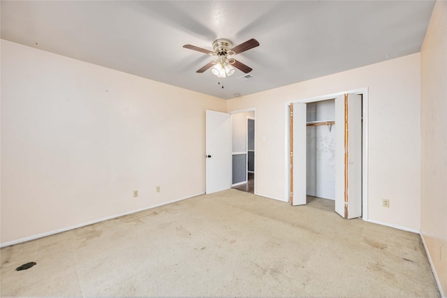 unfurnished bedroom featuring a closet, visible vents, a ceiling fan, and light colored carpet