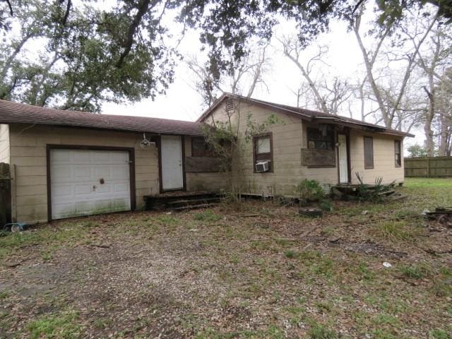 ranch-style house with cooling unit and a garage