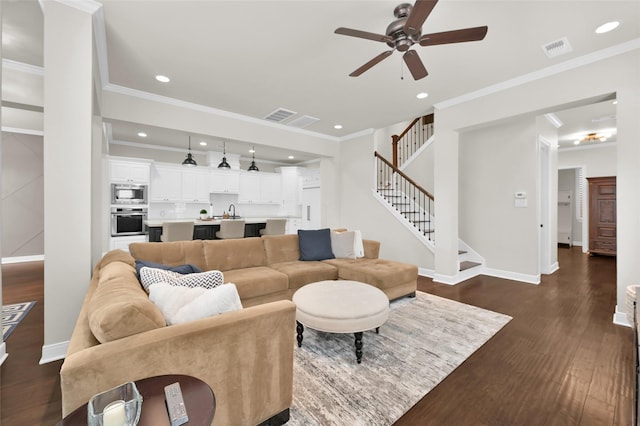 living area with visible vents, baseboards, dark wood-style floors, stairs, and recessed lighting