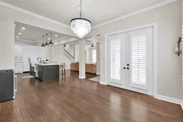 interior space with ornamental molding, recessed lighting, dark wood finished floors, and baseboards