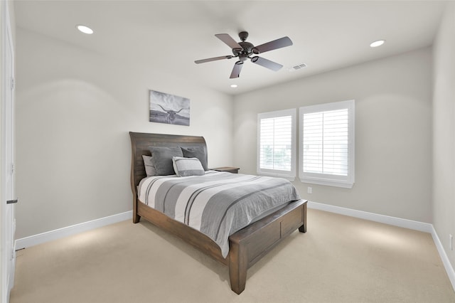 bedroom featuring visible vents, light carpet, and baseboards