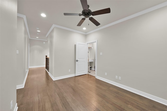 empty room with recessed lighting, wood finished floors, and baseboards