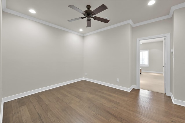 empty room with crown molding, recessed lighting, dark wood finished floors, and baseboards