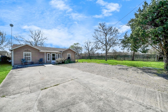 exterior space featuring a lawn and fence