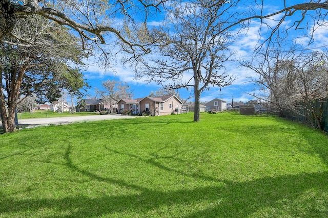 view of yard featuring a residential view and fence