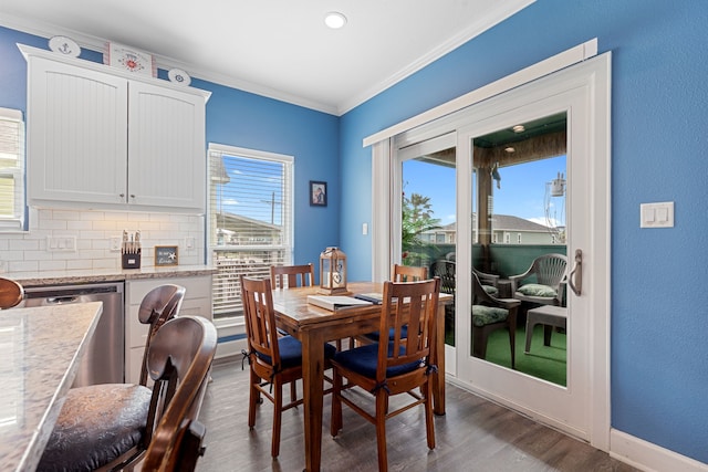 dining room featuring dark wood-type flooring and crown molding