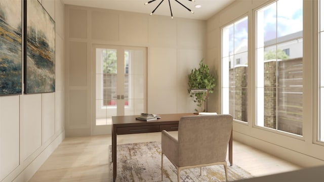 home office with an inviting chandelier and french doors