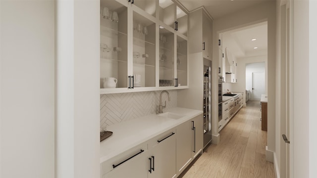 2002 Park St, Houston, TX 77019 - bar featuring a sink, tasteful backsplash, light wood finished floors, and recessed lighting