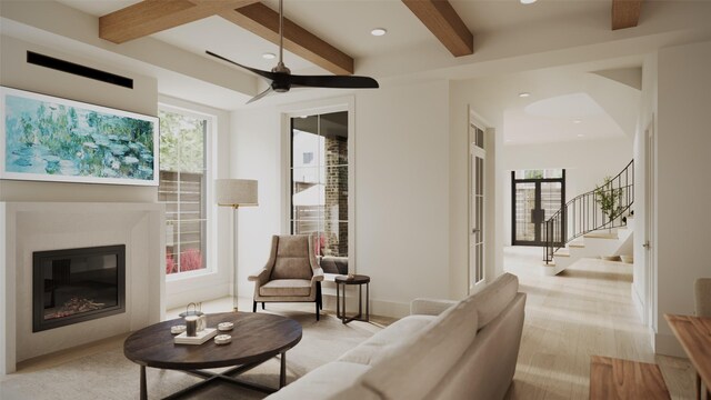 2002 Park St, Houston, TX 77019 - living area featuring a glass covered fireplace, beam ceiling, plenty of natural light, recessed lighting, and stairs