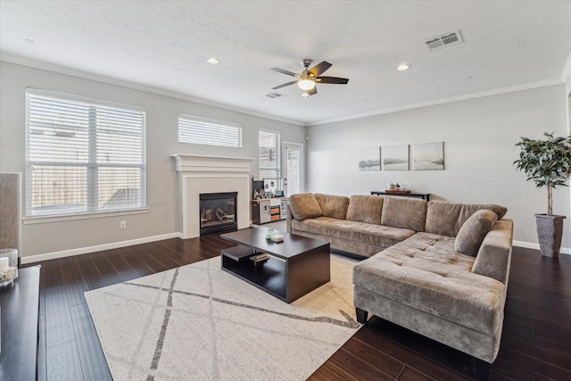 living room featuring a textured ceiling, ceiling fan, crown molding, and dark hardwood / wood-style flooring