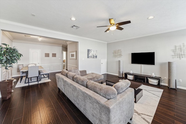 living room featuring crown molding, a textured ceiling, ceiling fan, and dark hardwood / wood-style floors