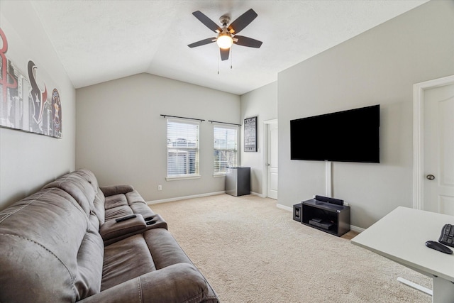 carpeted living room featuring ceiling fan, vaulted ceiling, and a textured ceiling