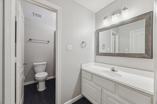 bathroom featuring a textured ceiling, toilet, vanity, and tile patterned flooring