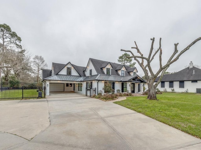 view of front of property with a garage, central AC unit, and a front lawn