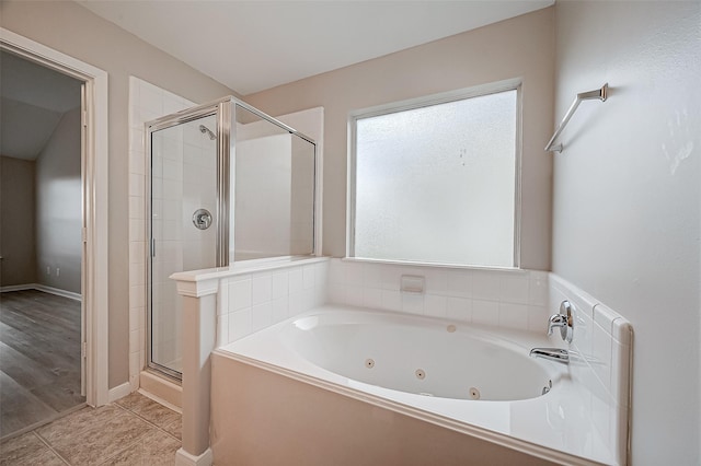 bathroom with a whirlpool tub, a shower stall, and tile patterned flooring