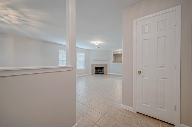 hall with light tile patterned floors and baseboards