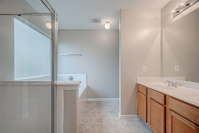 bathroom featuring double vanity, visible vents, a sink, a bath, and tile patterned floors