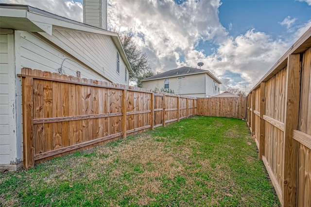 view of yard with a fenced backyard