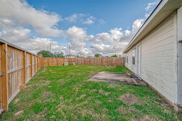 view of yard featuring a patio area and a fenced backyard