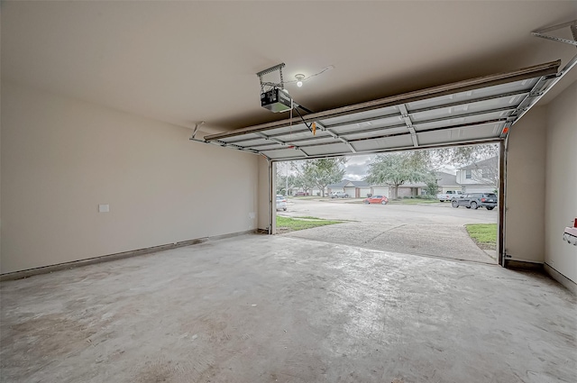 garage featuring baseboards and a garage door opener