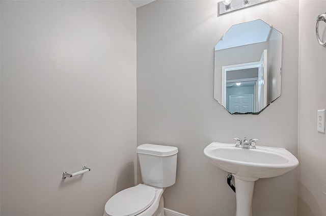 bathroom featuring toilet and a sink