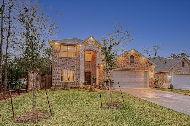 front facade featuring a front yard and a garage