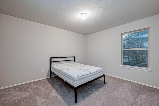 unfurnished bedroom with carpet floors and a textured ceiling