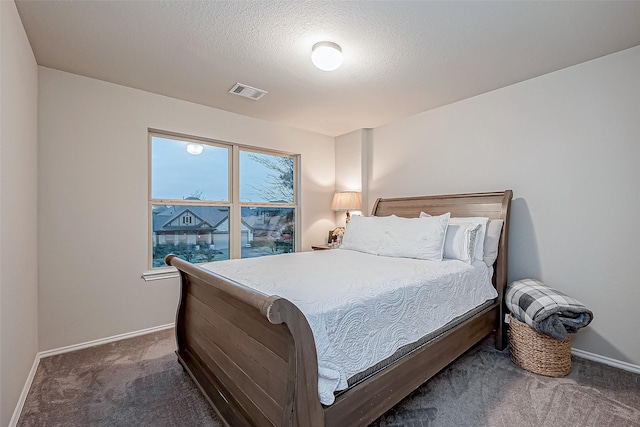 carpeted bedroom featuring a textured ceiling