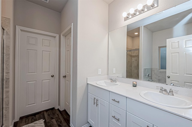 bathroom with vanity, hardwood / wood-style floors, and an enclosed shower