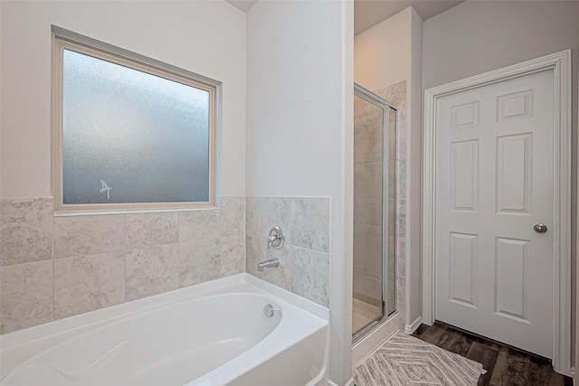 bathroom with separate shower and tub and hardwood / wood-style flooring