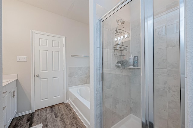 bathroom with separate shower and tub, vanity, and wood-type flooring