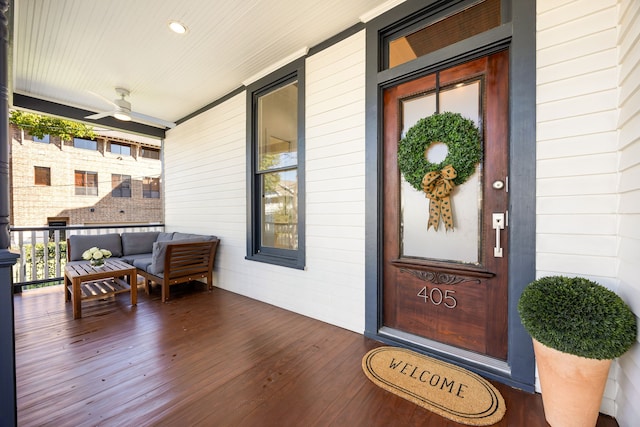 entrance to property featuring covered porch and ceiling fan